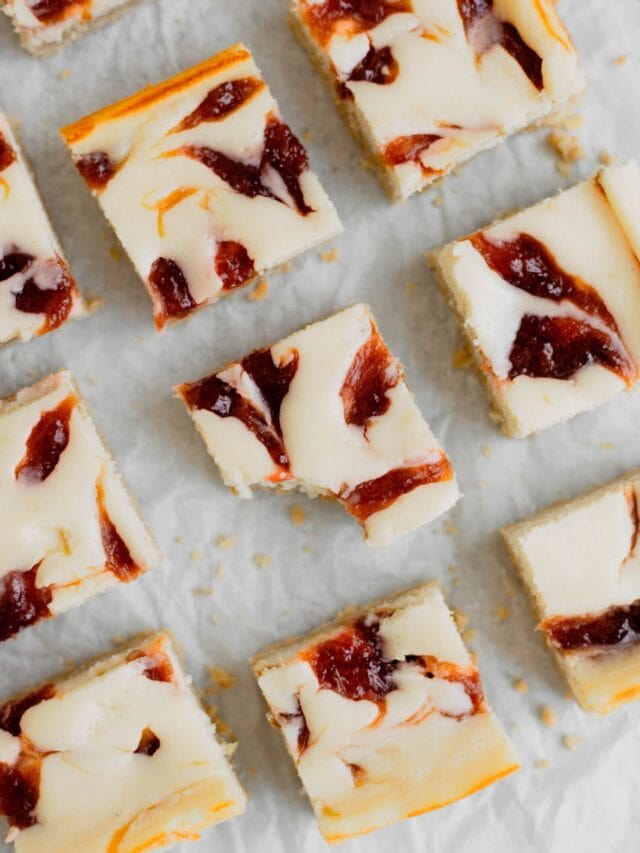 Rhubarb Cheesecake Square sit on a piece of parchment paper