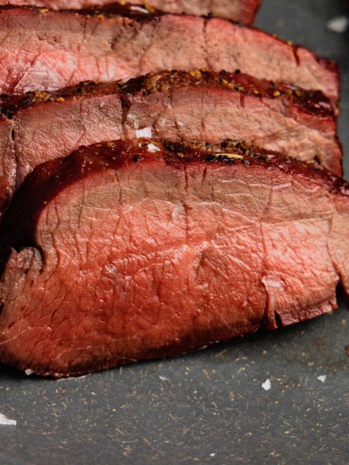 A close up of smoked venison backstrap on a gray plate.