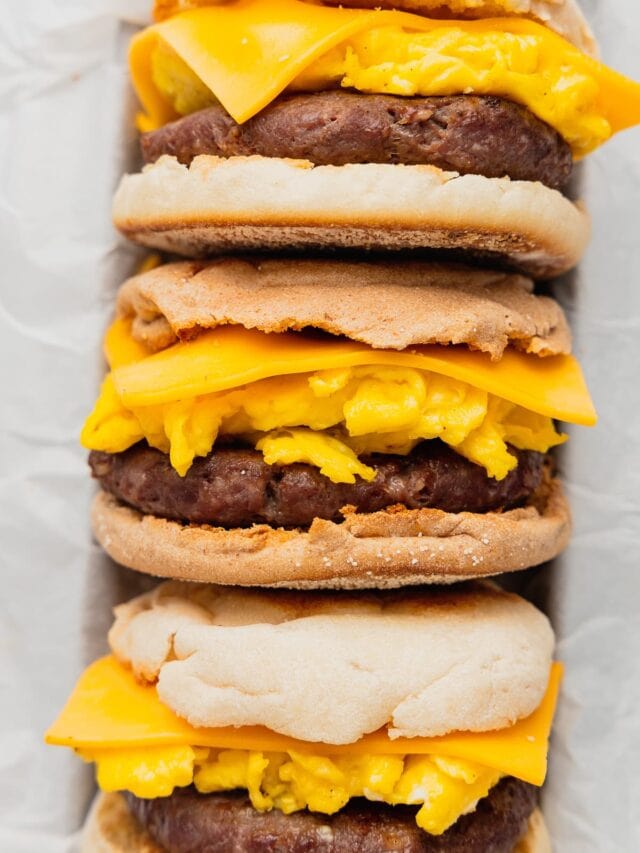 A stack of venison breakfast sandwiches on English muffins.
