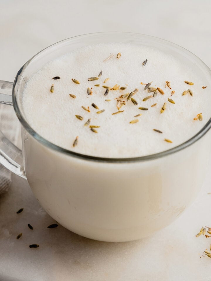 A London Fog latte in a mug garnished with dried lavender.